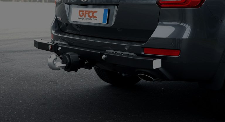 Image shows a tow bar at the back of a modern car. The licence plate has the Grange Farm Car Care logo on it.